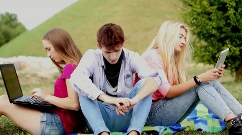 Three friends relaxing and having fun in park Stock Footage 55233308