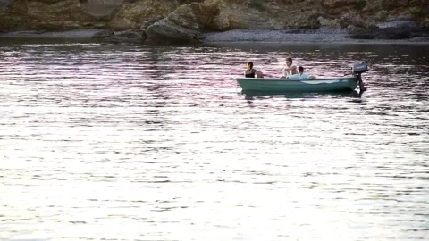 Three friends relaxing at a boat in Cabo de Palos seascape at sunset 動画素材 130894853