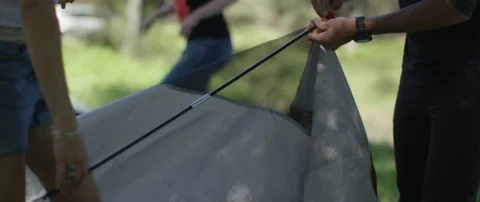 Three friends setting up a tent at campsite Stock Footage 69199167