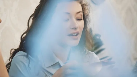 Three friends sitting in a cafe with a smart phone and having a funny Stock Footage 113681627