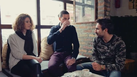 Three friends smiling and talking in cafeteria Stock Footage 95905991