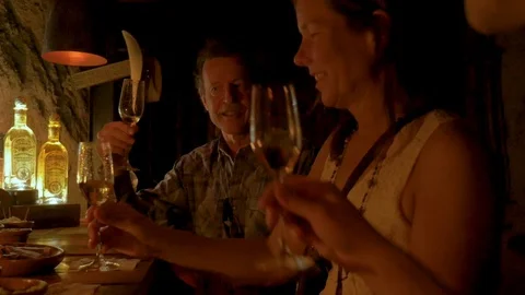 Three friends tasting and cheering with Fortaleza tequila in a dark bar Stock Footage 90222743
