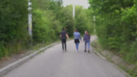 Three friends walking on a road Video stock 133578936
