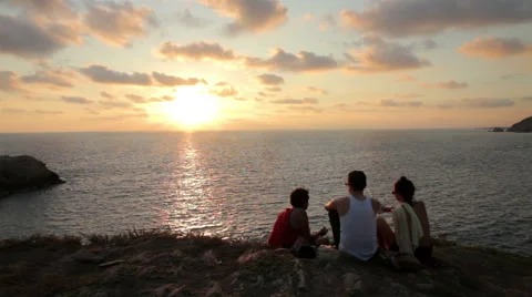 Three friends watching the sunset in the Oaxaca coast. Stock Footage 49672582