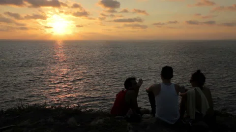 Three friends watching the sunset in the Oaxaca coast. Stock Footage 49672742