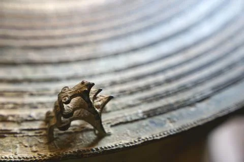 Three frogs on surface of ancient bronze drum. Frog drum or Rain drum in Thai Stock Photos