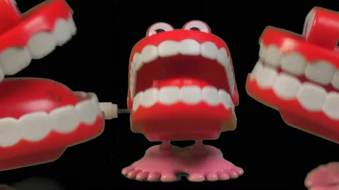 Three fun toy chattering teeth sharing a chatty joke. Stock Footage 237804929
