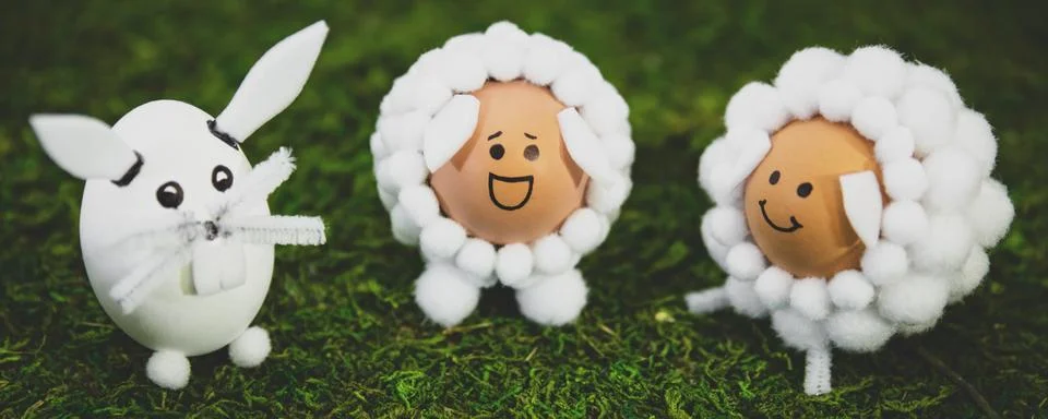 Three funny easter eggs on green meadow, selfmade easter egg ideas Stock Photos