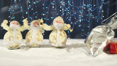Three funny Santa Clauses with their gifts congratulate on Christmas Stock Footage 82978396