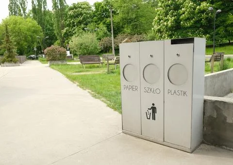 Three garbage cans Paper, Glass, Plastic in the city park. Stock Photos