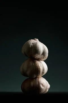 Three garlics on a black table. High quality Stock Photos