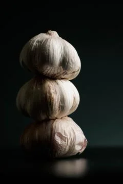 Three garlics on a black table. High quality Stock Photos
