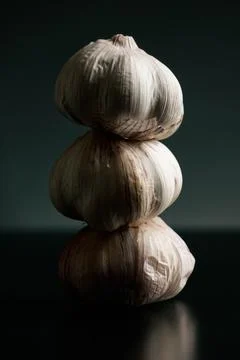 Three garlics on a black table. High quality Stock Photos