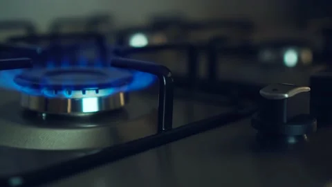 Three gas burners burn simultaneously on stove in dark. Circular gas-jet Stock Footage 202530066