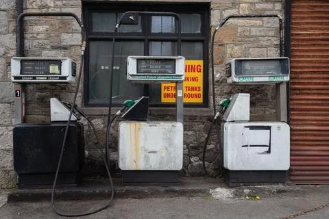 Three gas pumps that have a missing gas light on them Stock Photos