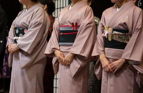 Three geisha standing in a row. Stock Photos