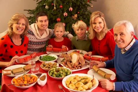 Three Generation Family Enjoying Christmas Meal At Home Stock Photos