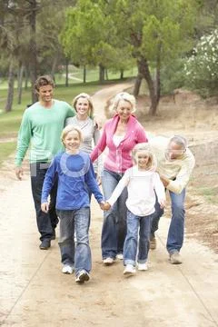 Three Generation Family enjoying walk in park Stock Photos