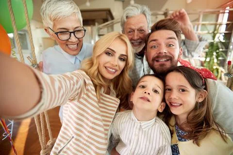 Three generation family having a good time while taking a selfie at home toge Stock Photos