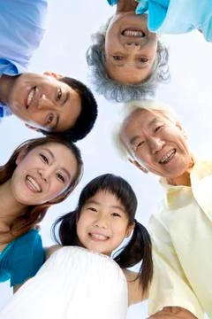 Three generation family looking down Stock Photos