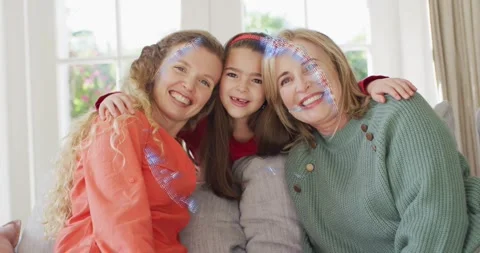 Three generation family on sofa smiling while initiating rotating tech globe 動画素材 316885243