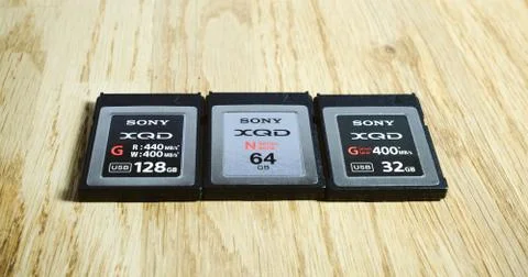Three generation of XQD card reader on table 스톡 사진