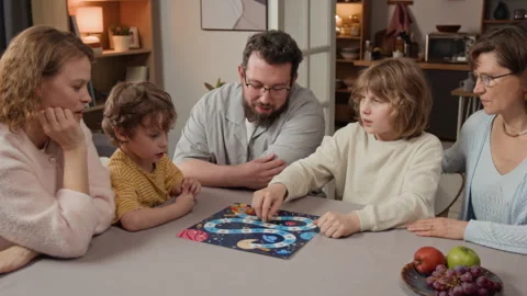 Three Generations of Family Playing Board Game Together Stock Footage 340345803