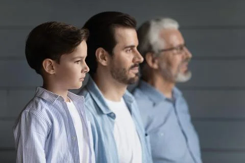 Three generations of men pose together showing unity Stock Photos