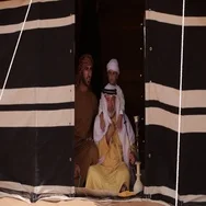 Three Generations Of Men Sitting Inside A Tent In The Desert. Stock Footage
