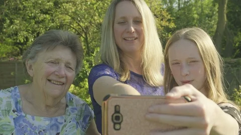 Three generations of the same family taking a selfie Video stock 89984717