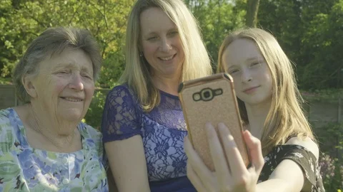 Three generations of the same family taking a selfie Video stock 89999059