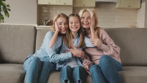 Three generations of women look at camera, cute little girl hug mom and granny Video stock 171754005