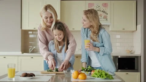 Three generations of women spend time together at the kitchen, grandmother Stock Footage 155154478