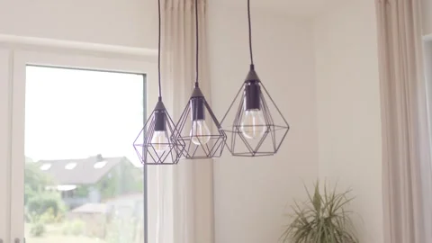Three Geometric Pendant Lamps by Bright Window, Modern Home Interior, Low Angle Видео 341571376