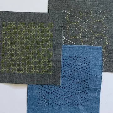 Three geometric sashiko embroidery patterns on textile Stock Photos
