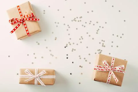 Three gift box on white background with confetti. Flat lay copy space Stock Photos