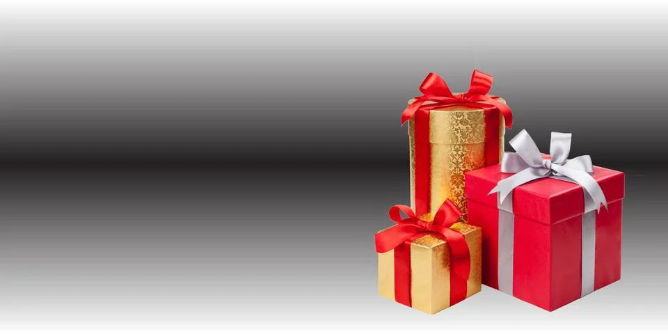 Three gift boxes are arranged against a dark gradient background	 Stock Photos