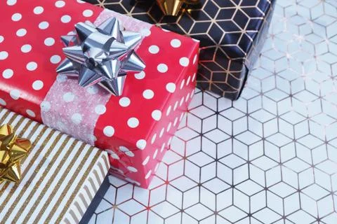 Three gift boxes black-gold and red in white peas at an angle on a white pape Stock Photos