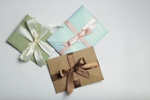 Three gift certificates with milk-colored, brown and pink ribbons, gift cer.. Stock Photos