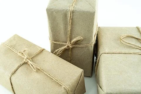 Three giftboxes in brown kraft packaging close-up set of gifts Stock Photos