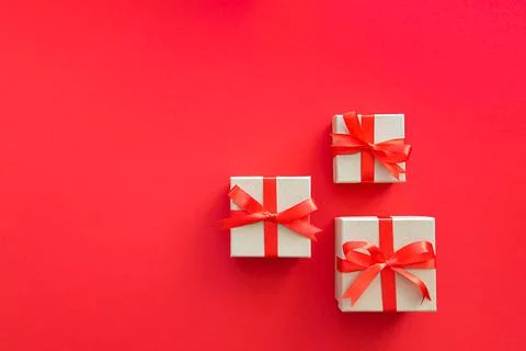 Three gifts on a red background. Stock Photos