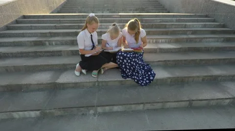 Three girl students doing lessons on the steps 스톡 동영상 51604751
