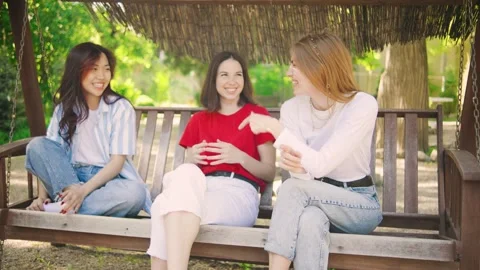 Three girlfriends of different ethnicities: an Asian woman, a brunette, and a Video stock 286214907
