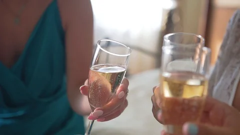 Three girlfriends drink champagne. Close-up of hands and glasses Stock Footage 108941645