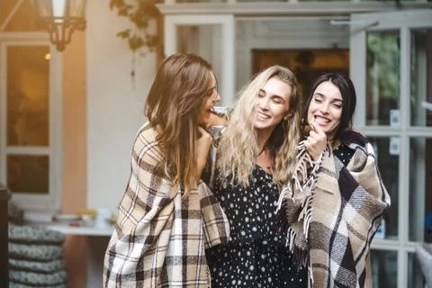 Three girlfriends on the veranda Stock Photos