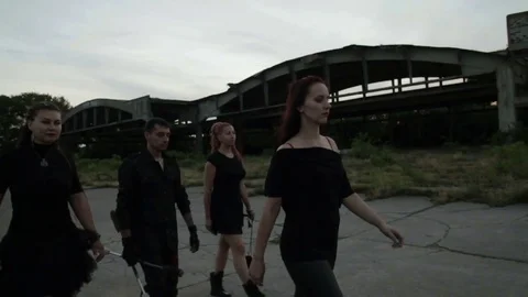 Three girls and a guy are walking along the old German airfield. They are Stock Footage 79663227