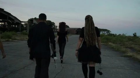 Three girls and a guy are walking along the old German airfield. They are Stock Footage 79665190