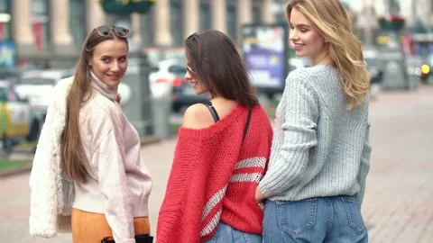 Three girls are walking down the street Stock Footage 144948404
