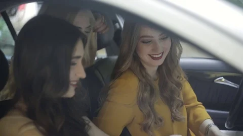 Three girls in cars plot the route of their journey with a map Vídeos de archivo 77071972