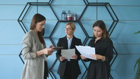 Three girls cheking their documents at office. Stock Footage 130868310